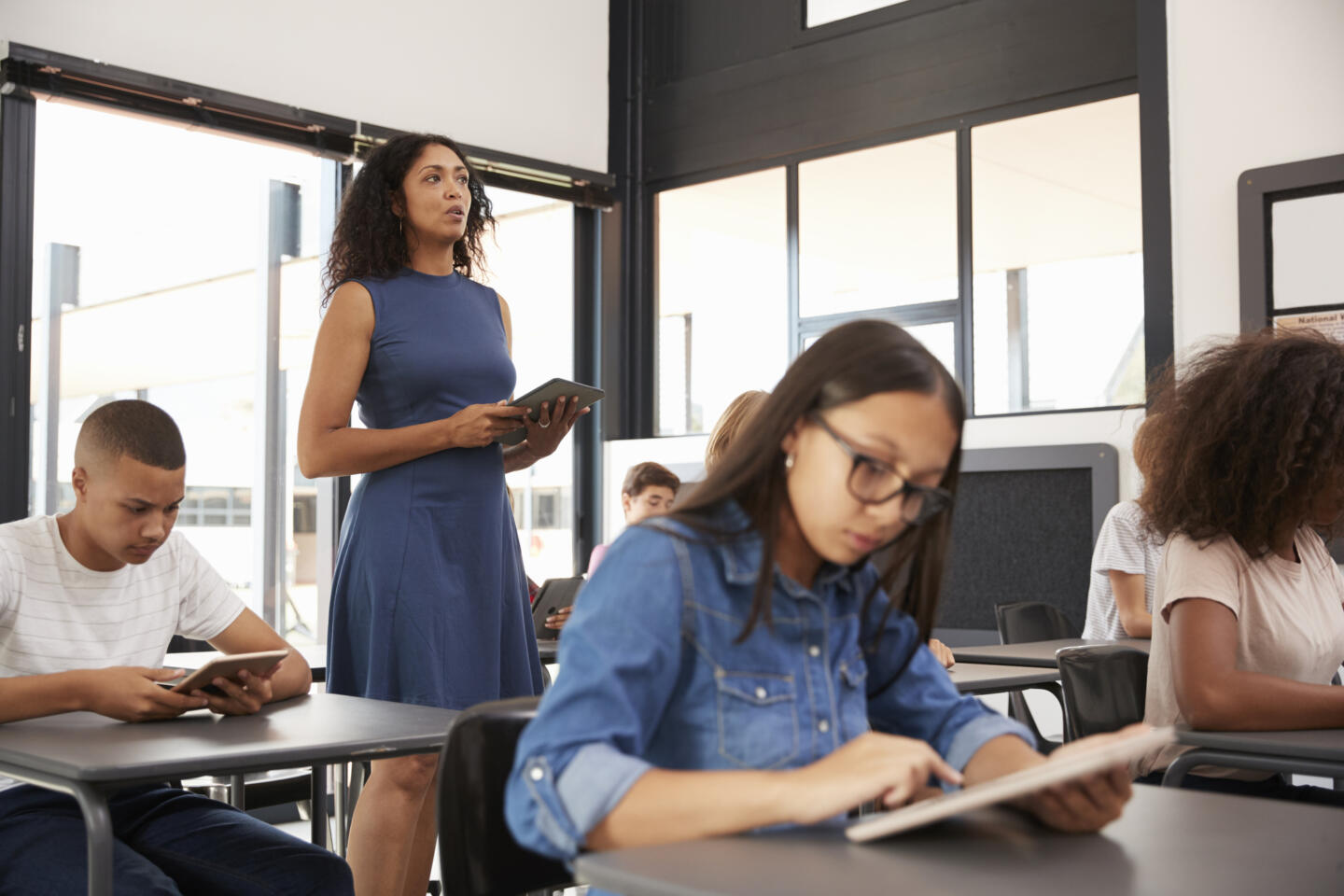 Teacher standing in the middle of her high school class